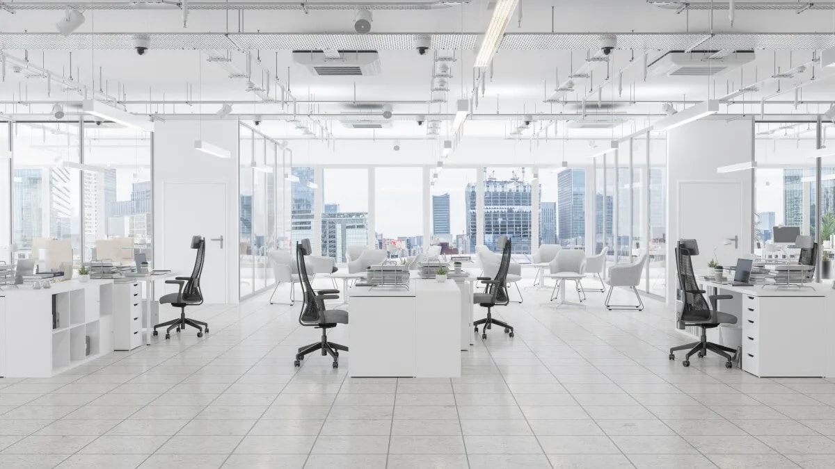 Open plan office with white walls, white floors and white desks