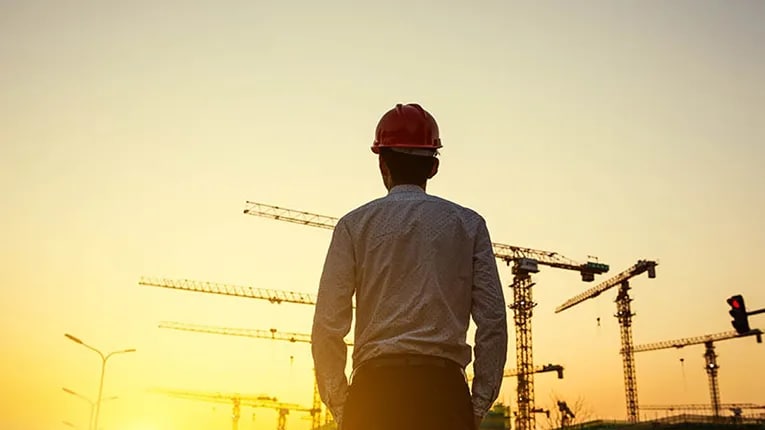 A man looking into the sunset on a commercial land parcel