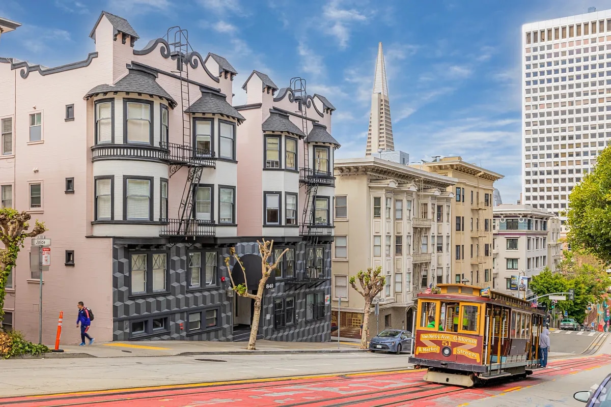 View of a cable car and apartment buildings in downtown San Francisco, CA.