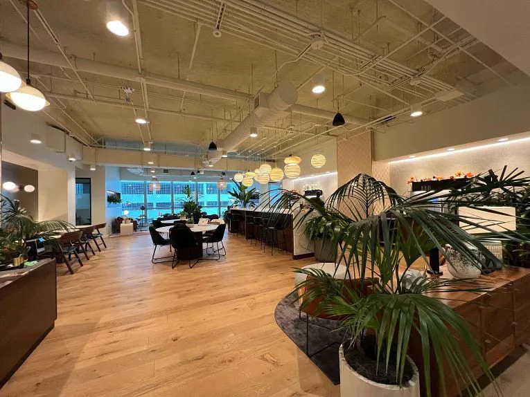 Interior view of an industrious coworking office with wood floors and high ceilings on Brickell Ave. in Miami, FL.