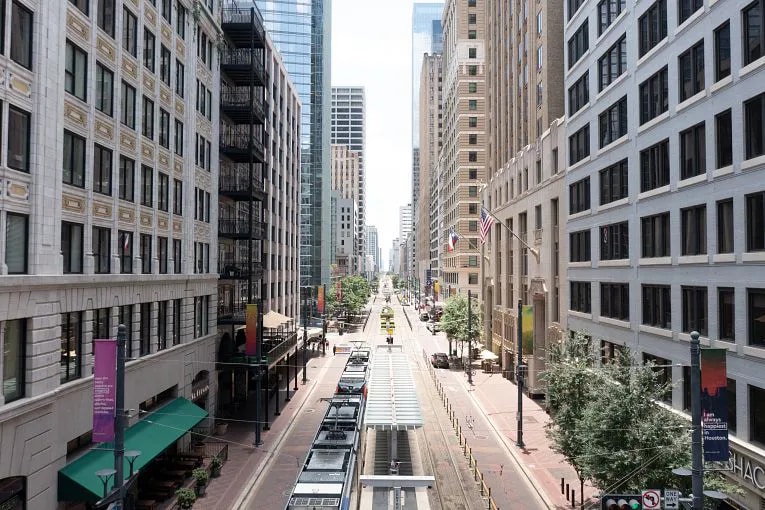 Ariel view of a street in Downtown Houston with commercial properties on both sides of the street