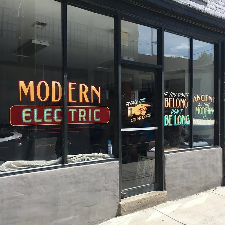 Hand-painted signs for Modern Electric Tattoo Co. in Richmond, Virginia.