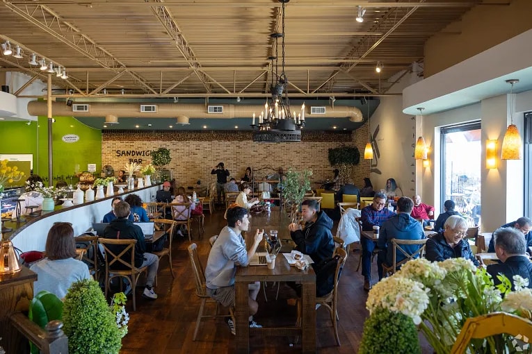 Interior view of a waiter and diners at a restaurant in Doraville, GA.