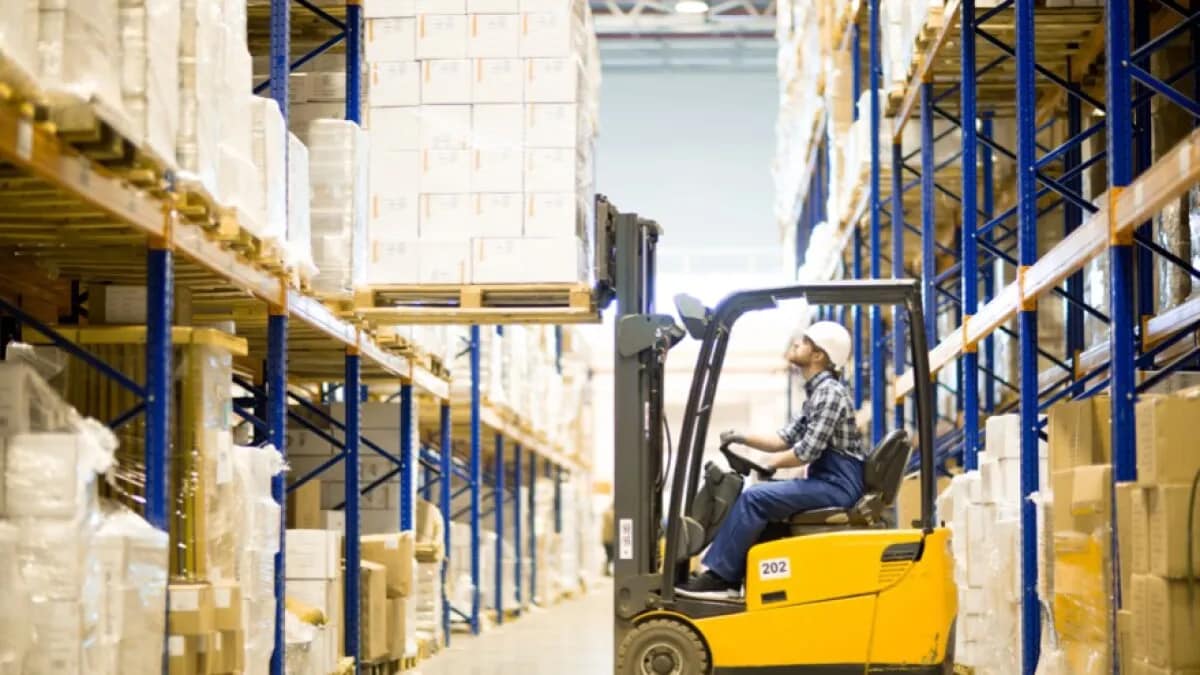 Man driving a forklift inside a warehouse