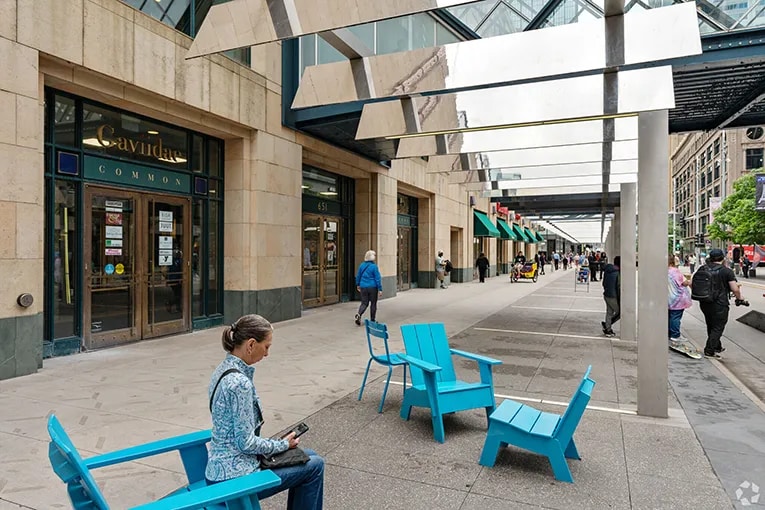 A rest area among retail properties with pedestrians