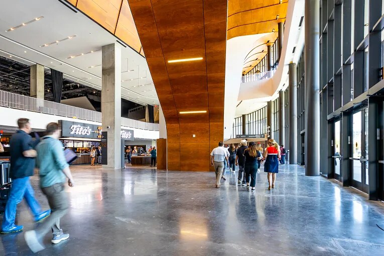 Interior view of a hotel building with guests walking through the lobby