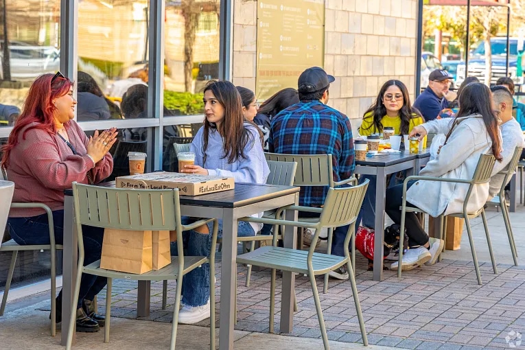 People sitting outside at a restaurant in Old East neighborhood of Dallas, TX.