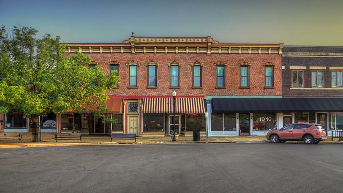 Comercial building made of bricks with a red and white striped awning