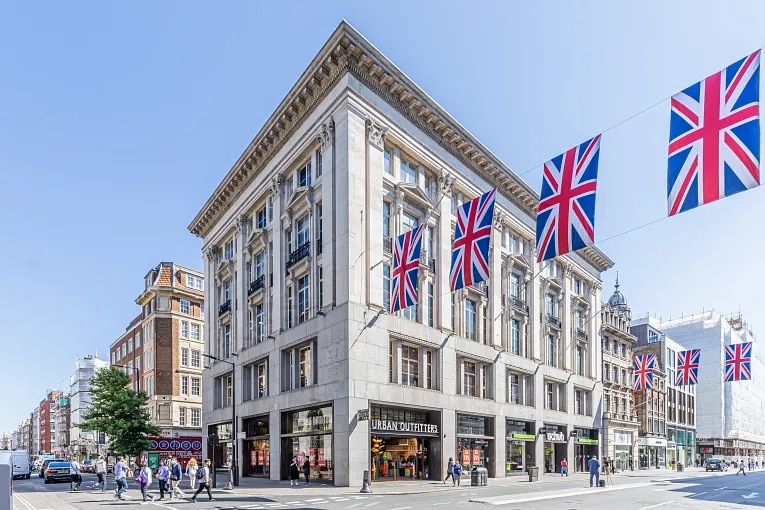 Street level exterior view of office buildings with flags in London, England